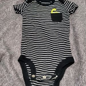 Cute striped onesie with dinosaur in pocket